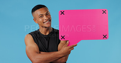 Buy stock photo Man, speech bubble and smile in studio portrait for opinion for gym subscription by blue background. Personal trainer, pink board and sign with mock up space, review or tracking markers in Brazil