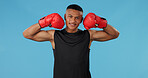 Man, strong and portrait in studio for box, fight and muay thai with exercise, battle and competition. Boxer, face and athlete flex on blue background for training, fitness and workout with mma sport