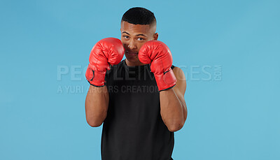 Buy stock photo Man, fist and portrait in studio for box, fight and muay thai with exercise, battle and competition. Boxer, face and strong athlete on blue background for training, fitness and workout with mma sport