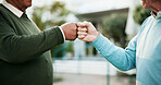 Hands, men and fist bump outdoor with communication for retirement agreement, partnership and celebration. Elderly, people and friends with deal support for respect, achievement and understanding