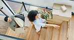 Couple, moving and above with box by stairs for real estate, investment and packing for new home. Man, woman and furniture with cardboard package in house for property, mortgage or marriage residence