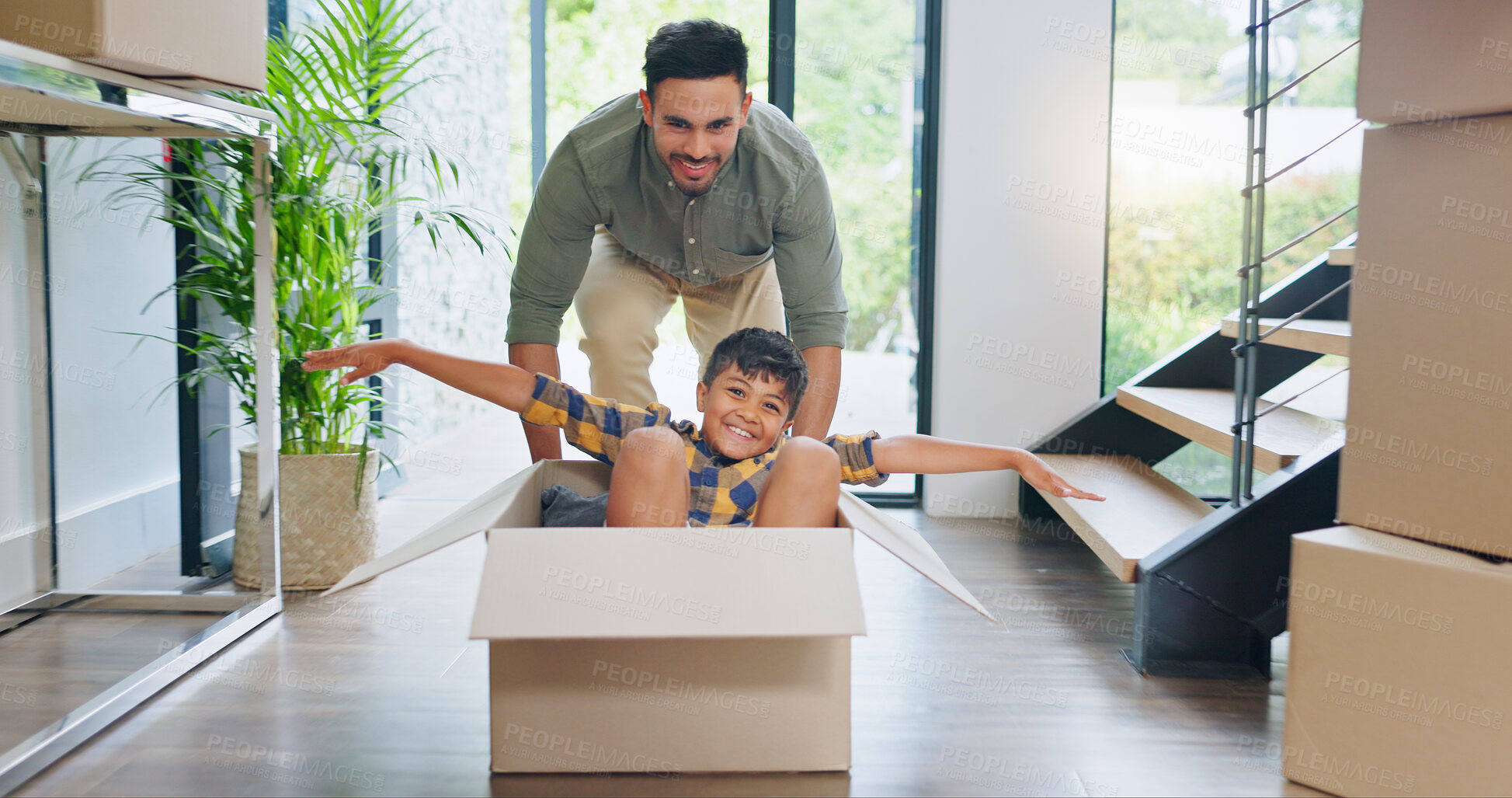 Buy stock photo Father, child and playing in box in new house with property investment, real estate and security. Portrait, people and boy in dream home with fun activity, celebration or excited for mortgage success