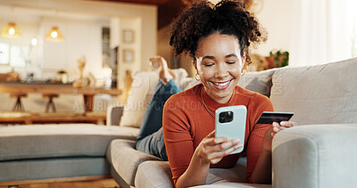 Buy stock photo Credit card, online shopping and phone with woman on sofa in living room of home for bank payment. Ecommerce, fintech and transaction with smile of happy African person in apartment for purchase