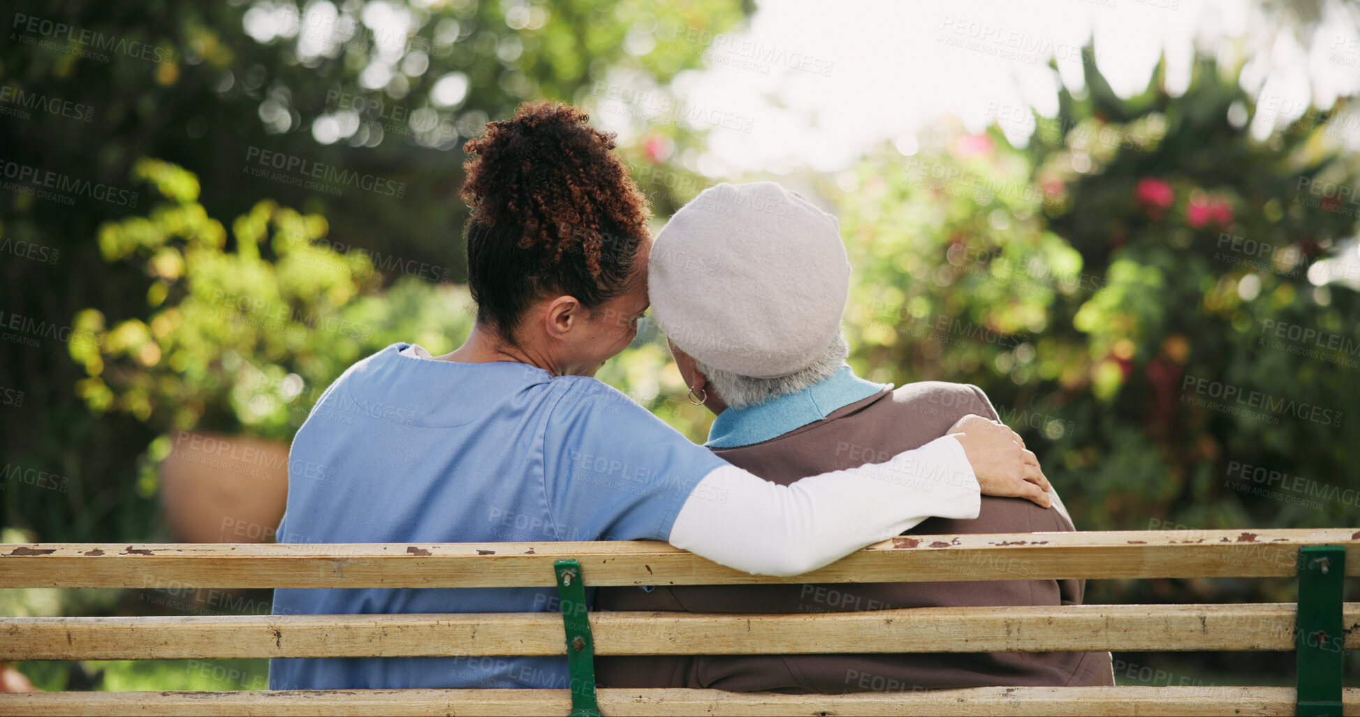 Buy stock photo Caregiver, senior woman and hug on bench outdoor for nursing support, retirement and comic conversation. Smile, volunteer and people with embrace for wellness assistance, empathy and residential care