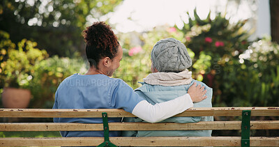 Buy stock photo Volunteer, senior woman and hug on bench outdoor for nursing support, retirement and comic conversation. Back, caregiver and people with embrace for wellness assistance, empathy and residential care