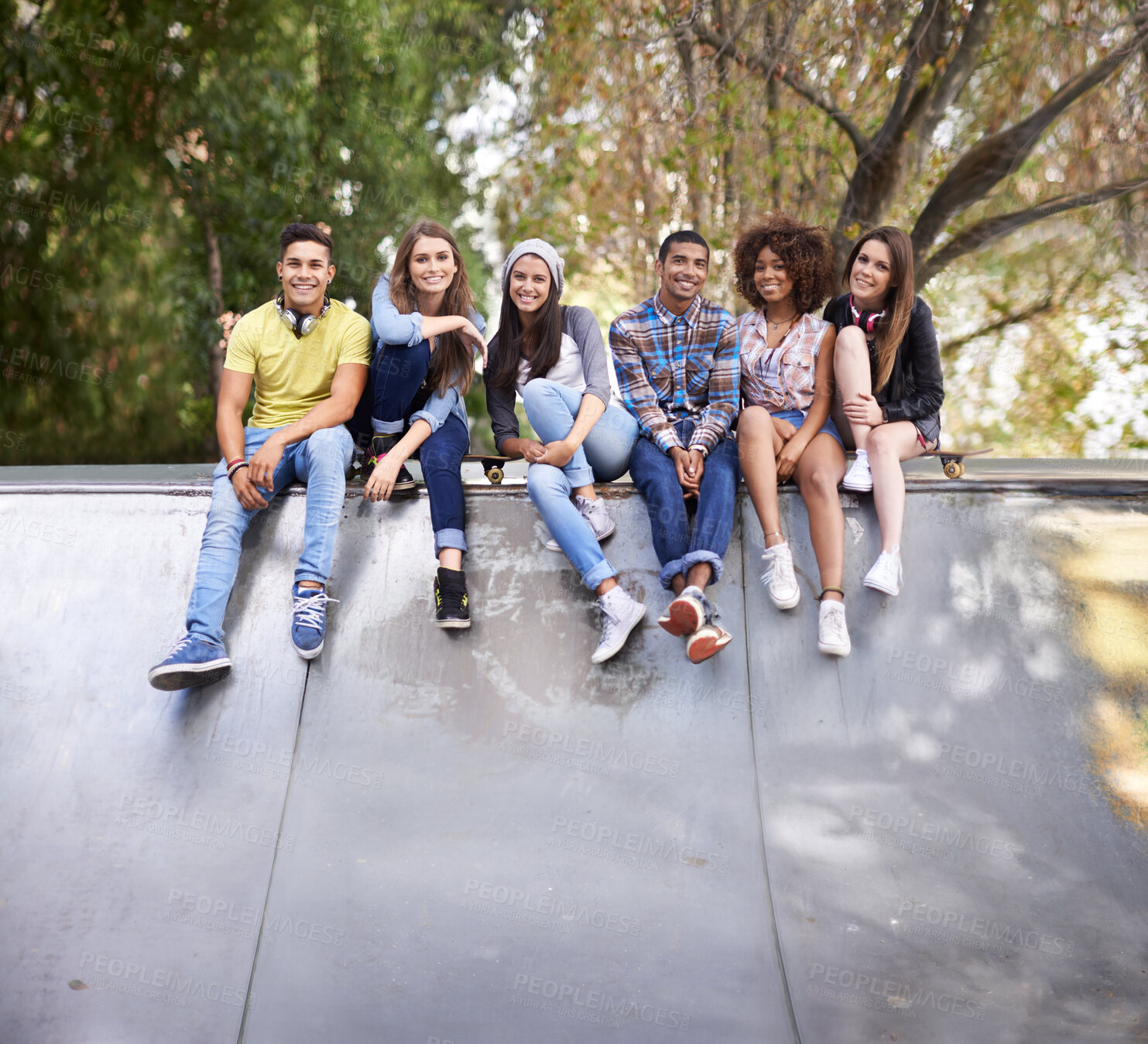Buy stock photo Portrait, happy and group of teenagers at skatepark in city for bonding, having fun and sitting together. Smile, diversity and young gen z friends in with skateboard in town for practice or training.