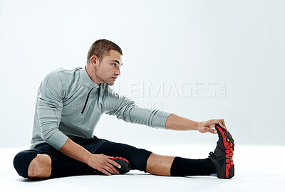 Buy stock photo Workout, man and stretching legs on floor for body wellness, warm up exercise or getting ready for fitness. Athlete, studio and thinking on white background mockup with training, preparing or balance