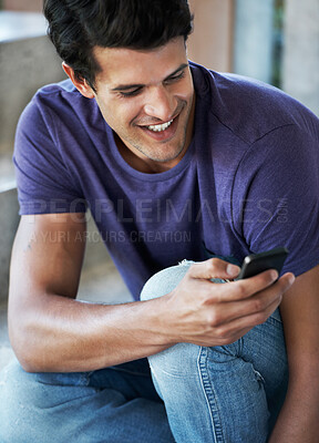 Buy stock photo Happy man, typing and social media with phone for communication, chatting or texting at home. Young, male person or user with smile on mobile smartphone for online browsing, app or news at house