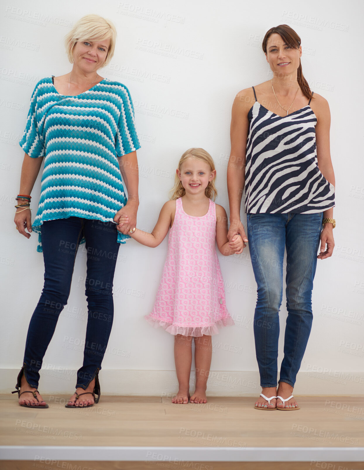 Buy stock photo Portrait, lesbian and family with child at house for adoption commitment, holding hands and relationship care. People, girl and relax for affection, bonding together and lgbtq mothers with loyalty