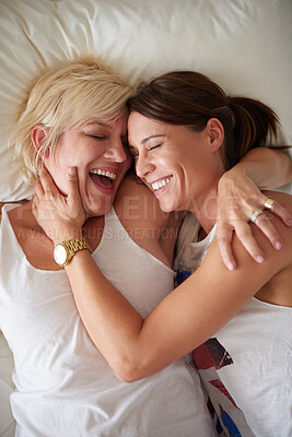 Buy stock photo Lesbian, couple and laugh with hug on bed for funny joke, marriage commitment and morning romance. Above, lgbtq women and relax with affection, bonding together and loyalty for relationship at house