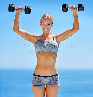 Buy stock photo Happy woman, portrait and beach with dumbbells for weightlifting, workout or muscle training in nature. Young, female person or model with smile for fitness challenge, exercise or health and wellness