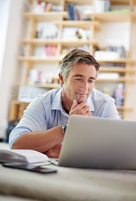 Buy stock photo Man thinking, laptop and employee in office on floor, research and website for startup proposal. Male person, brainstorming and internet for business project, professional perspective and ideas