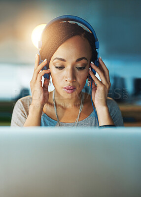 Buy stock photo African woman, laptop and headphones in office for planning, commitment and project deadline at night. Web designer, technology and music in workplace for radio, streaming and research inspiration