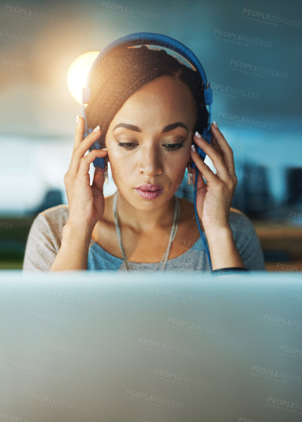 Buy stock photo African woman, laptop and headphones in office for planning, commitment and project deadline at night. Web designer, technology and music in workplace for radio, streaming and research inspiration