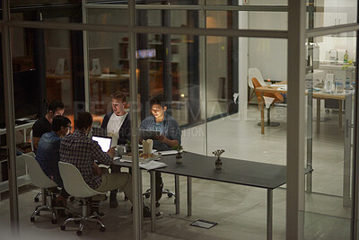Buy stock photo Shot of employees working in an office at night