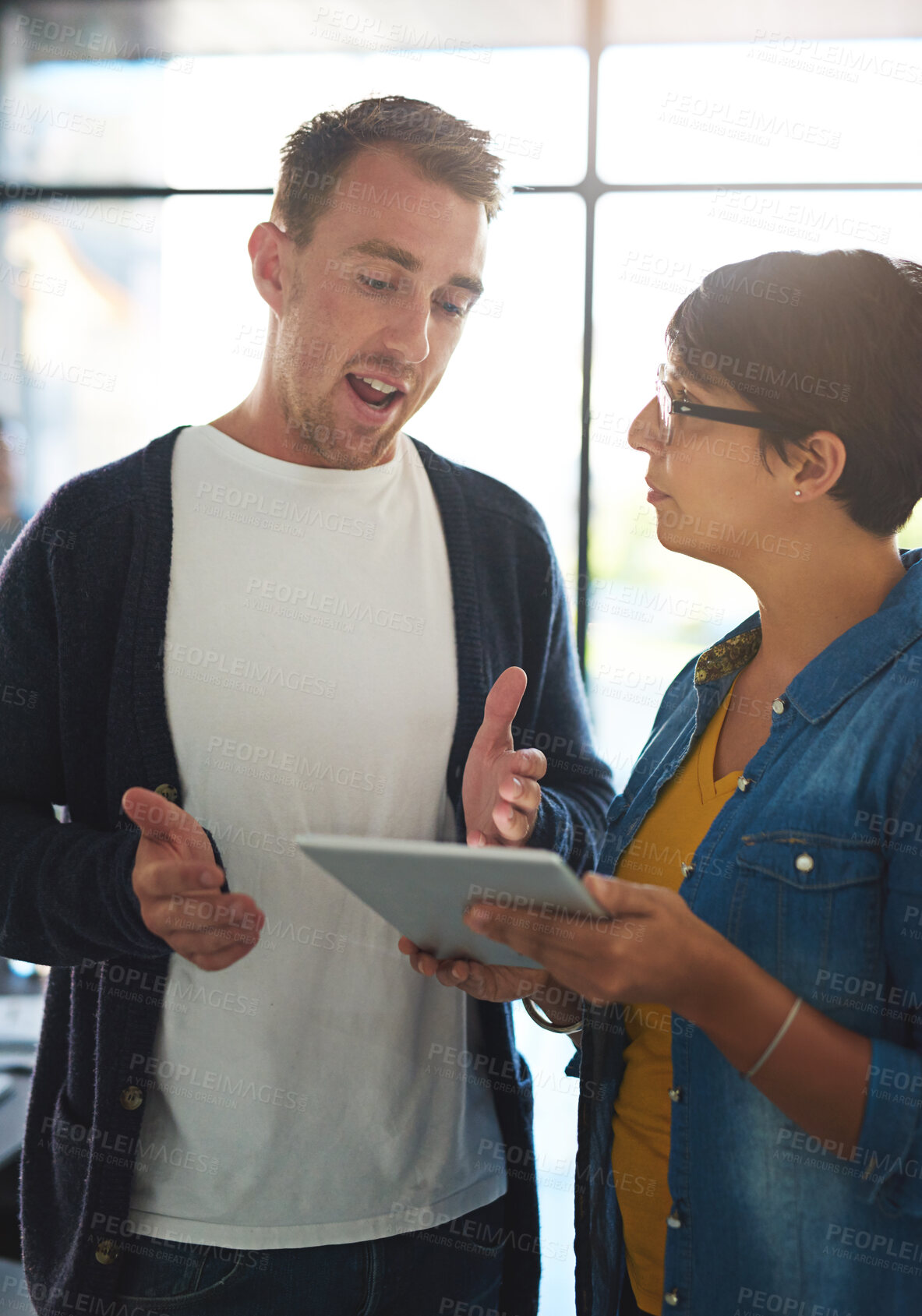 Buy stock photo Man, woman and tablet at startup, discussion and project at office with questions, strategy and teamwork. Business people, partnership and digital touchscreen with app for feedback at creative agency