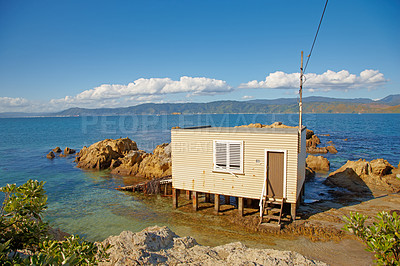 Buy stock photo Architecture, cabin and building on ocean outdoor for summer vacation, travel location and destination. Home, structure and coast cottage with nature, blue sky and holiday getaway on water in Miami