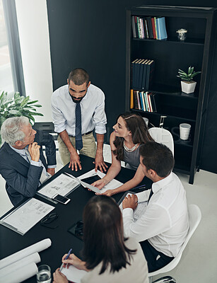 Buy stock photo Above, architecture and business people in meeting, tablet and conversation with planning in office. Employees, blueprints and coworkers with documents, tech and digital app with research or teamwork