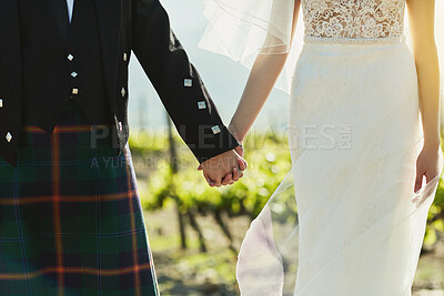 Buy stock photo Closeup, walking and couple with holding hands for wedding, married and bonding together in Scotland. People, bride and groom in zoom for special day, soulmate and commitment in marriage ceremony