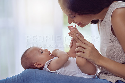 Buy stock photo Mother, baby and playing with feet in home for bonding, affection and support with growth and smile. Love, newborn and woman in nursery together with security, protection and morning routine for care