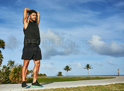 Buy stock photo Stretching, blue sky and man with arm exercise for running with race, marathon or challenge training. Fitness, nature and male sports athlete with muscle warm up for cardio workout outdoor in park.