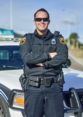 Buy stock photo Man, arms crossed and police officer on patrol, city and uniform for responsibility in town. Male person, law enforcement and cop for public service of security, sunglasses and authority in traffic