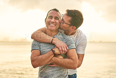 Buy stock photo Portrait, beach and hug with gay couple, kiss and bonding together with romance, travel and Bali. Queer people, face and men with embrace, love and ocean with adventure, relationship and marriage