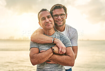 Buy stock photo Portrait, beach and hug with gay couple, adventure and bonding together with romance for travel. Queer people, face and men with embrace, sunset and ocean with relationship, tourism or marriage