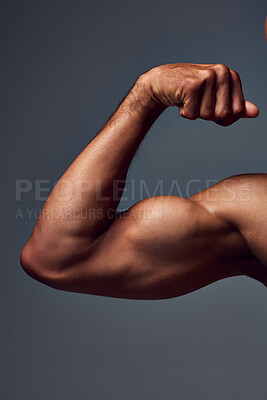 Buy stock photo Closeup, shirtless and man with muscle, arm and flexing on gray studio background. Person, guy and model with fitness, bicep and strong with wellness, healthy and training with power and challenge