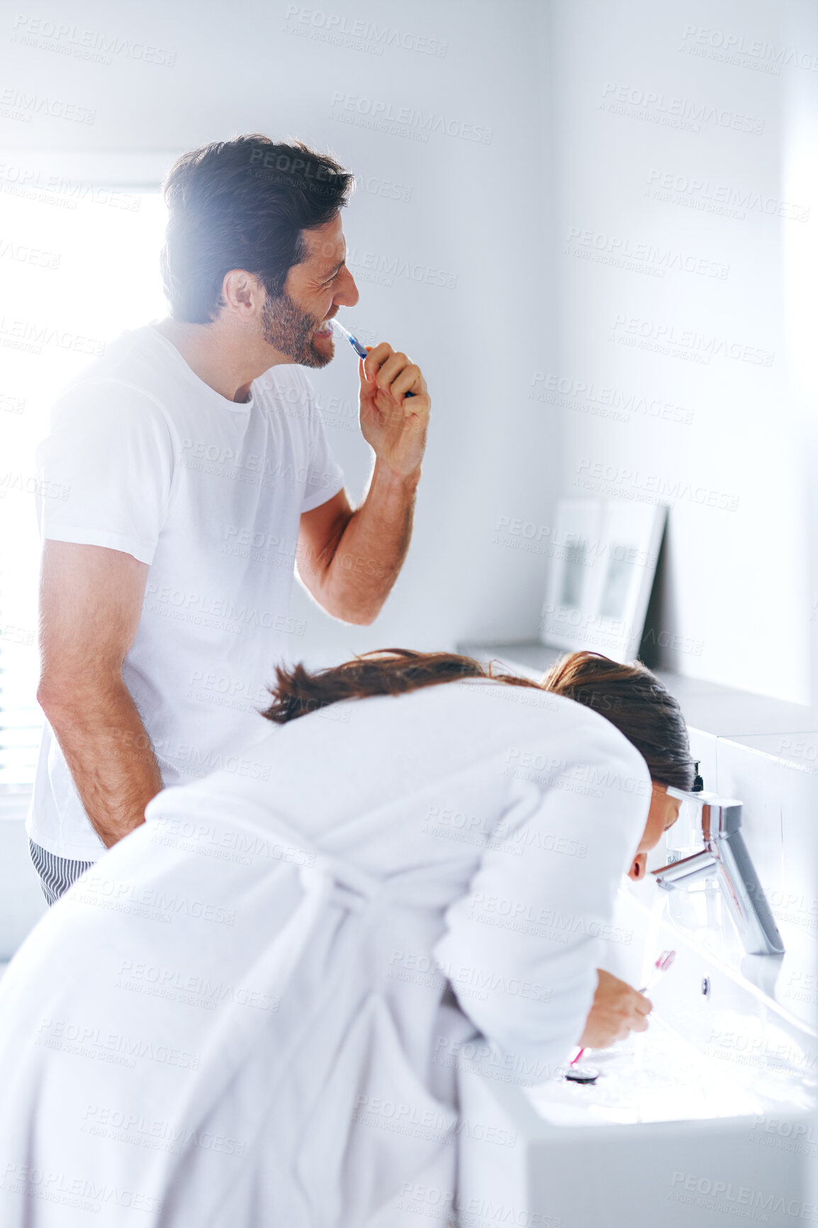 Buy stock photo Brushing teeth, self care and toothbrush with couple in bathroom for oral hygiene, breath and cleaning. Morning, wellness and dental with man and woman at home for gum treatment, toothpaste or health