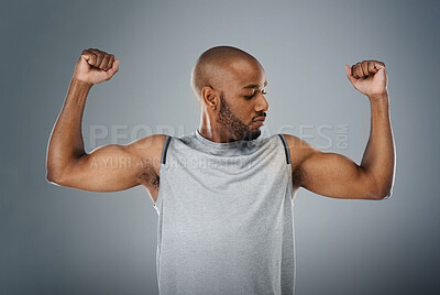 Buy stock photo Muscle flex, black man and confident in studio for fitness, workout and exercise on gray background. Male person, serious and trainer with sportswear with training for health, wellbeing and self care