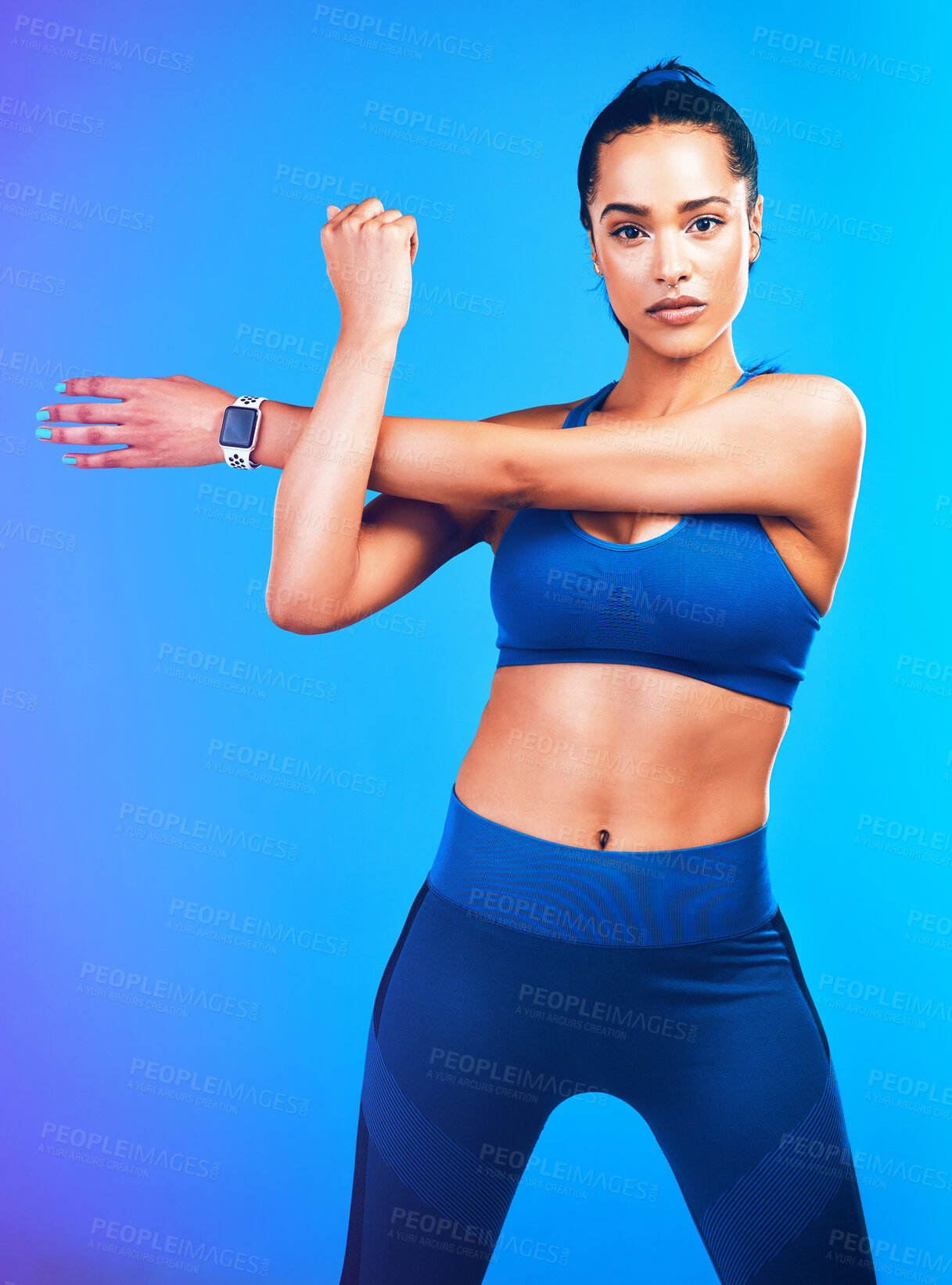 Buy stock photo Gym, stretching and portrait of woman on blue background for health, wellness and warm up in studio. Personal trainer, fitness coach and isolated person for arm exercise, training and workout