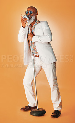 Buy stock photo Singing, senior and black man with soul, jazz and old school music with retro style and microphone in studio. Musician, cool and singer with sunglasses in groovy fashion and colorful background