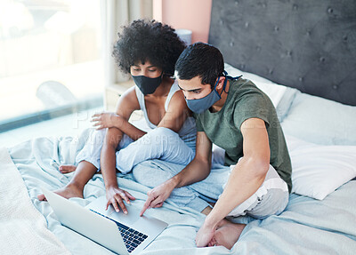 Buy stock photo Couple, mask and laptop on bed in home with quarantine together and symptoms research for mpox virus. Interracial people, germs prevention or technology in bedroom for streaming subscription in house