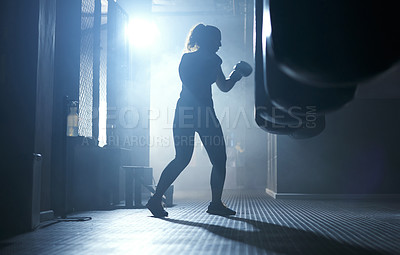 Buy stock photo Boxing, training and person in gym, sport and practice with punching bag, action and energy in dark. Exercise, healthy and boxer with skills for competition, workout and performance of fighter