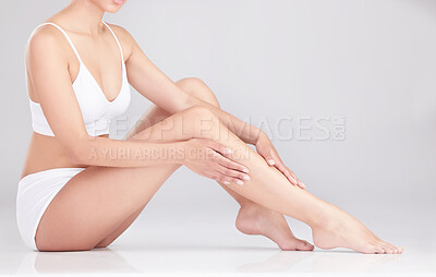 Buy stock photo Legs, hands and woman in studio for epilation, hair removal and natural beauty of body isolated on white background. Feet, touch and skincare of model waxing in underwear for dermatology or cosmetics