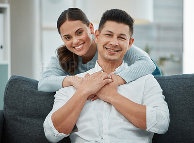 Buy stock photo Portrait, smile and hug for couple with living room, sofa and house together. Love, support and confidence with happy man and woman bonding with home, lounge and couch for romance and comfort