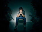 One mixed race male suffering mental illness in asylum. Caucasian schizophrenic man experiencing a depression while being surrounded by people on a stage theatre performance