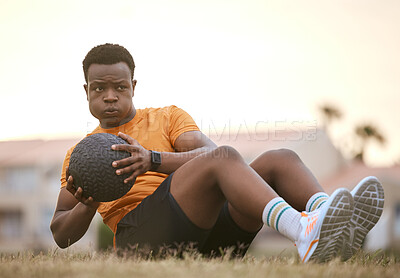 Buy stock photo Fitness, workout and black man with ball for outdoor morning training, wellness and challenge at park. Health, commitment and athlete on field for core muscle growth, development or exercise on grass