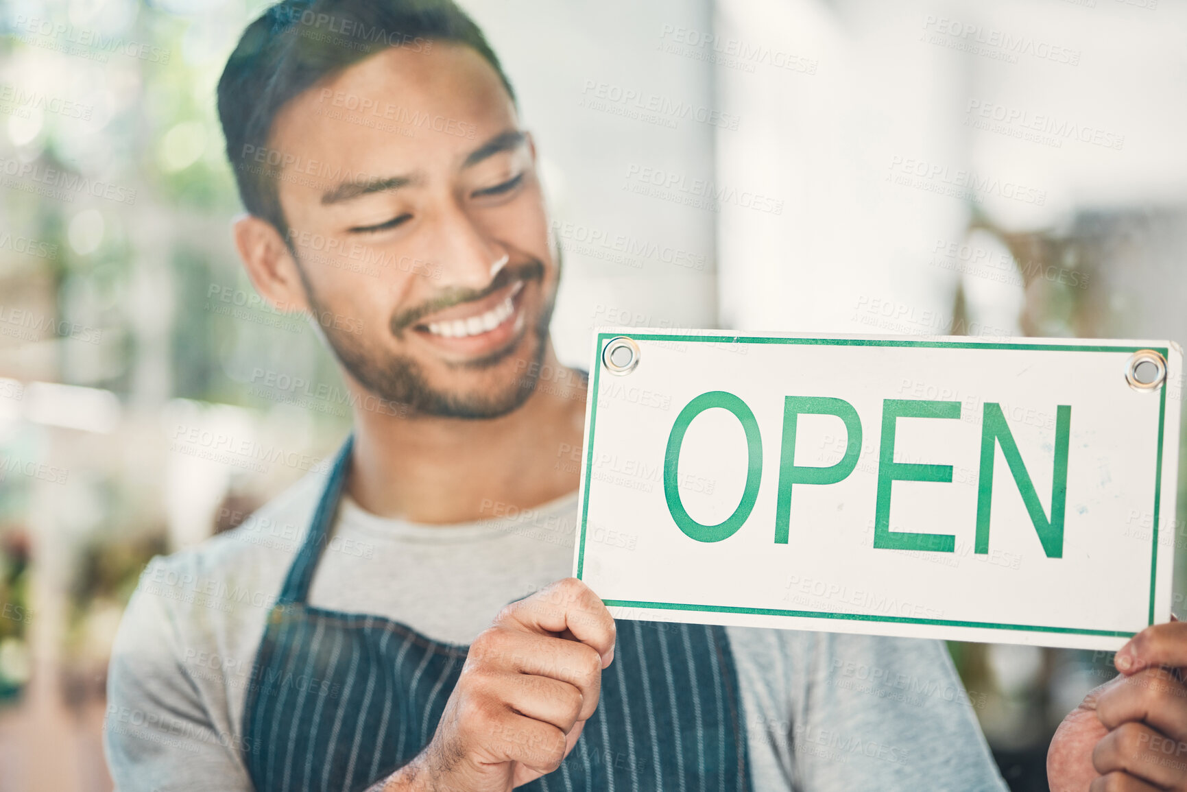 Buy stock photo Small business, asian man and smile with open sign by window, information and announcement to client. Male person, barista and happy with poster for cafe, coffee shop and excited for customer service