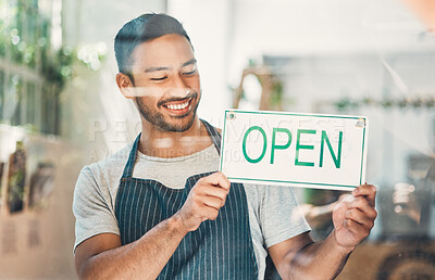 Buy stock photo Window, waiter and coffee shop with open sign or poster in small business, cafe or bistro. Male person, hospitality and happiness as barista, entrepreneur or employee for welcome as restaurant staff