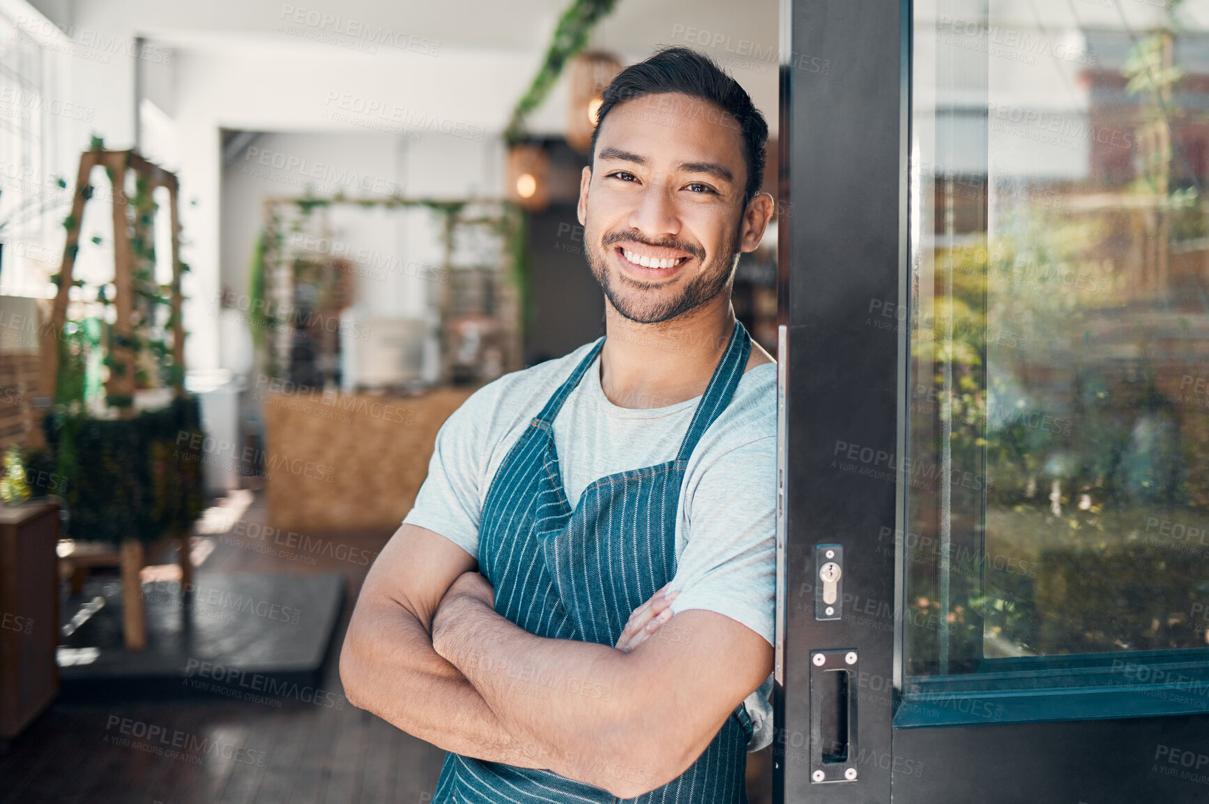 Buy stock photo Cafe, business owner and asian man in portrait for arms crossed, professional career and pride for welcome. Coffee shop, male person and barista in door for hospitality, customer service and smile