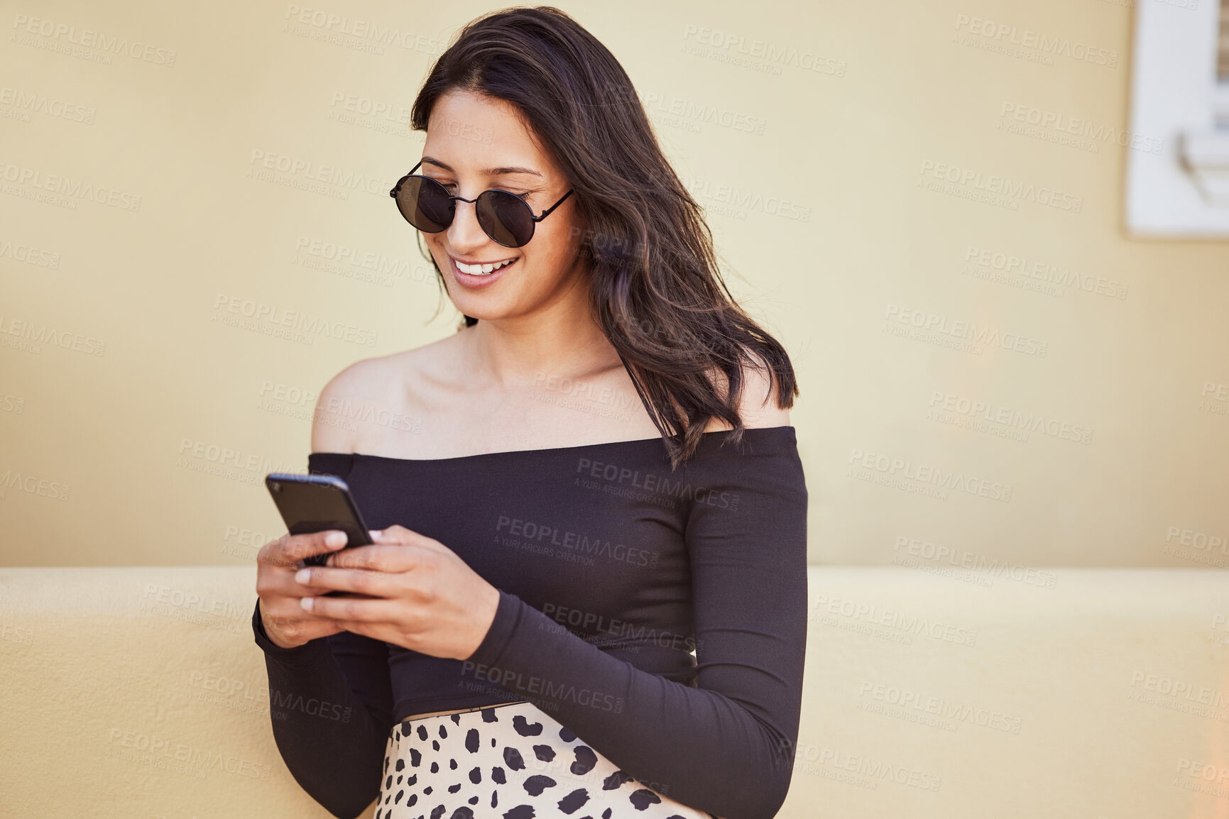 Buy stock photo Woman, sunglasses and holiday with phone in city for outdoor adventure, communication and travel update. Happy, smile and female person with technology by buildings for social media, post or vacation