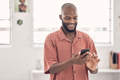 Buy stock photo Black man, phone and happy for texting at startup, office and notification on break at media company. Person, smartphone and smile for chat, scroll and mobile app on social network at creative agency