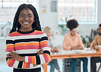 Young happy african american businesswoman standing with her arms crossed while in an office. Confident black female boss smiling and standing at work