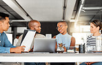 Group of diverse businesspeople having a meeting in an office at work. Business professionals talking in an office. Businesspeople planning together