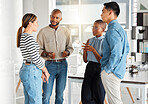 Group of diverse businesspeople having a meeting in a modern office at work. Business professionals talking and sharing ideas. Businesspeople planning together