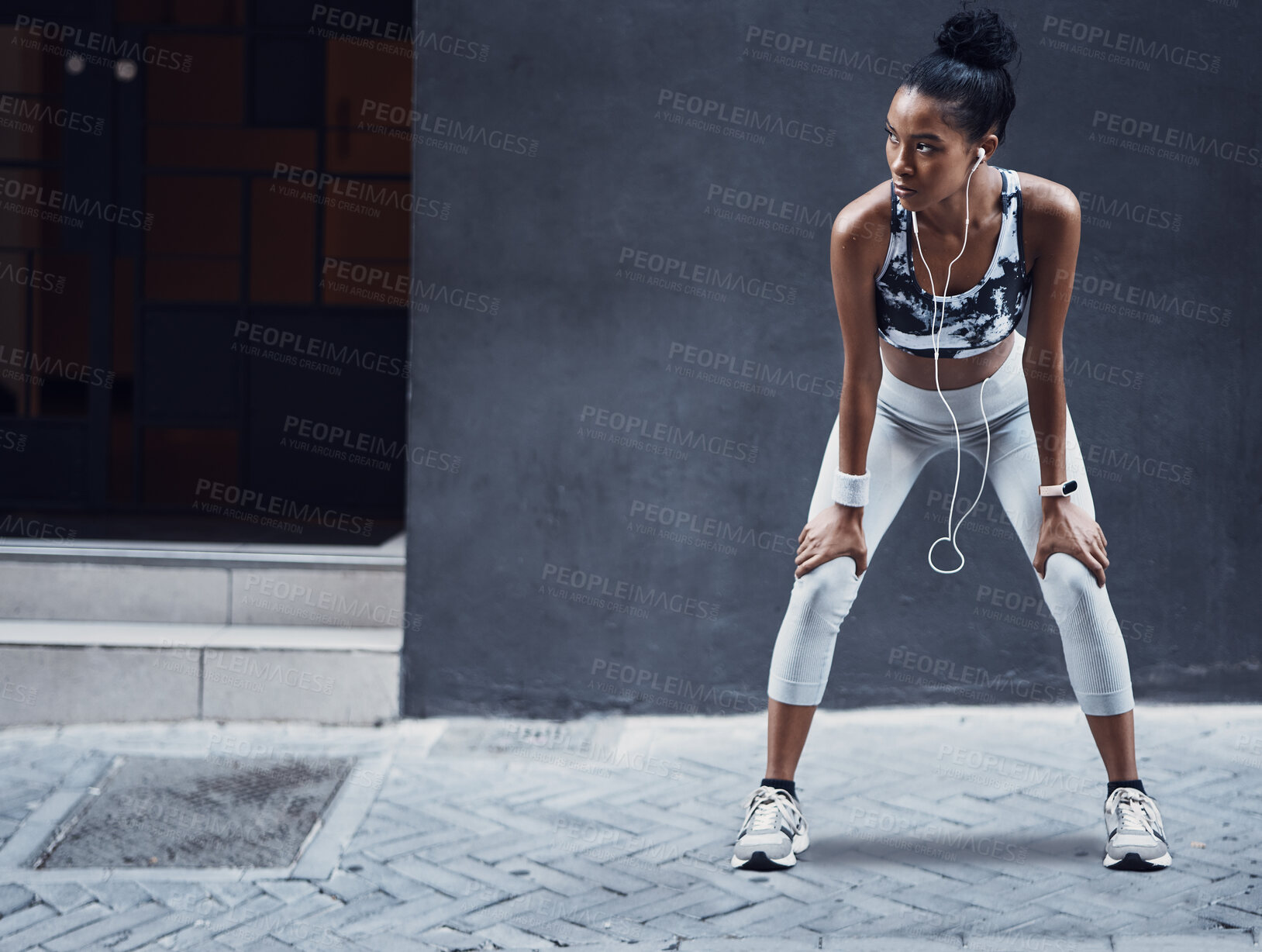 Buy stock photo Black woman, workout and city with earphones and break  from run and marathon training with mockup. Sport, music and audio on urban sidewalk with breathing and streaming fitness track with wellness