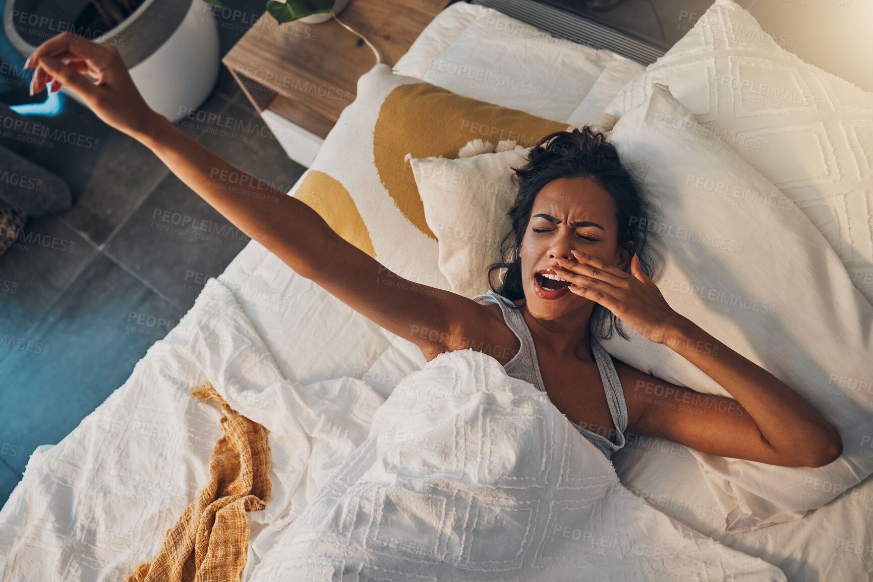 Buy stock photo Stretching, wake up and yawn with woman in bed of home for morning, sleeping or weekend. Exhausted, fatigue or tired female person resting to relax in bedroom of apartment, houuse or hotel on break