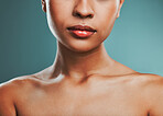 Closeup view of a mixed race woman posing against a green background. Female showing her healthy smooth soft skin in a studio